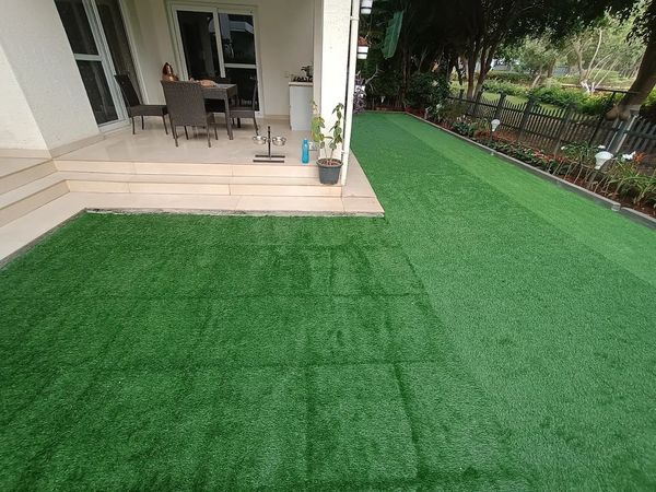 Artificial grass vs natural lawn comparison for Bangalore homes covering cost maintenance durability