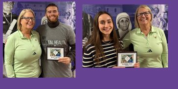 Two pairs of smiling people holding plaques, standing in front of a purple background with a statue.