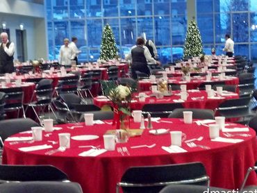 A festive dining hall with tables set for a holiday event.