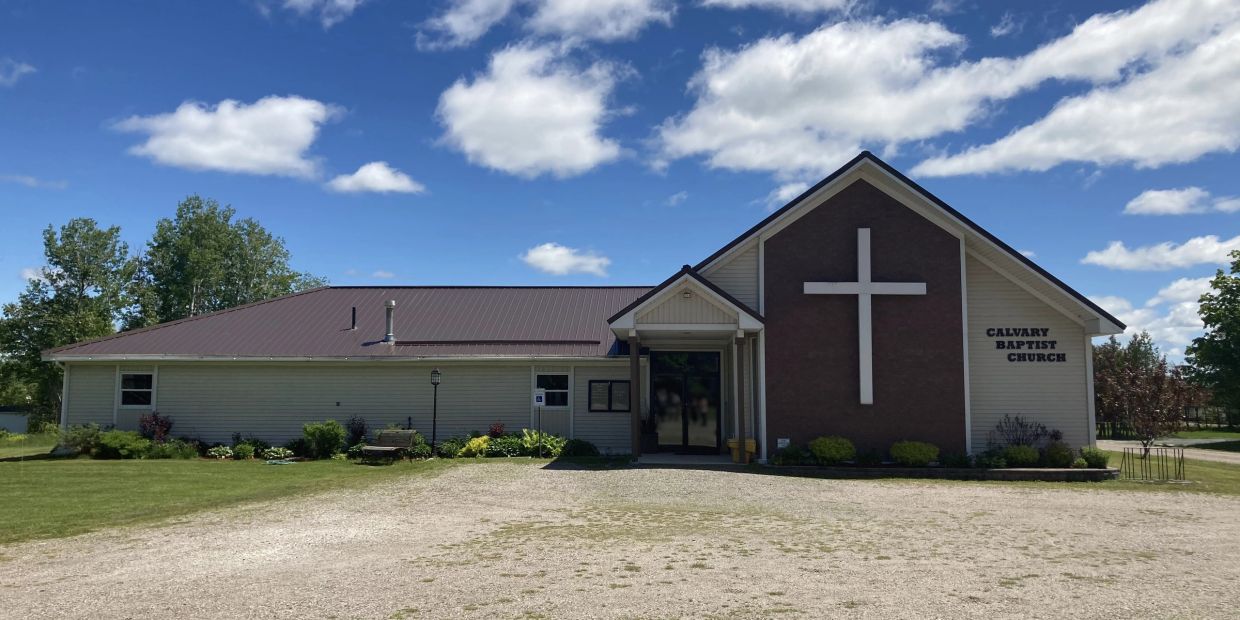 Calvary Baptist Church building with a large cross on front.