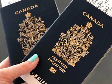 A person holding 2 Canadian passports