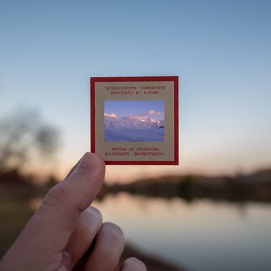 A person holding up a film slide
