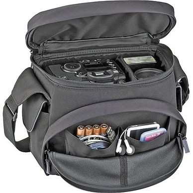 A camera bag containing batteries, earbuds, and a film camera