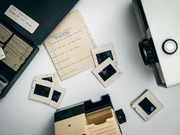 A collection of film slides scattered across a desk
