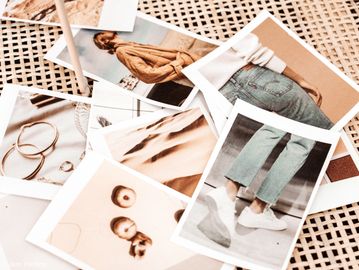 A collection of printed photos on a table