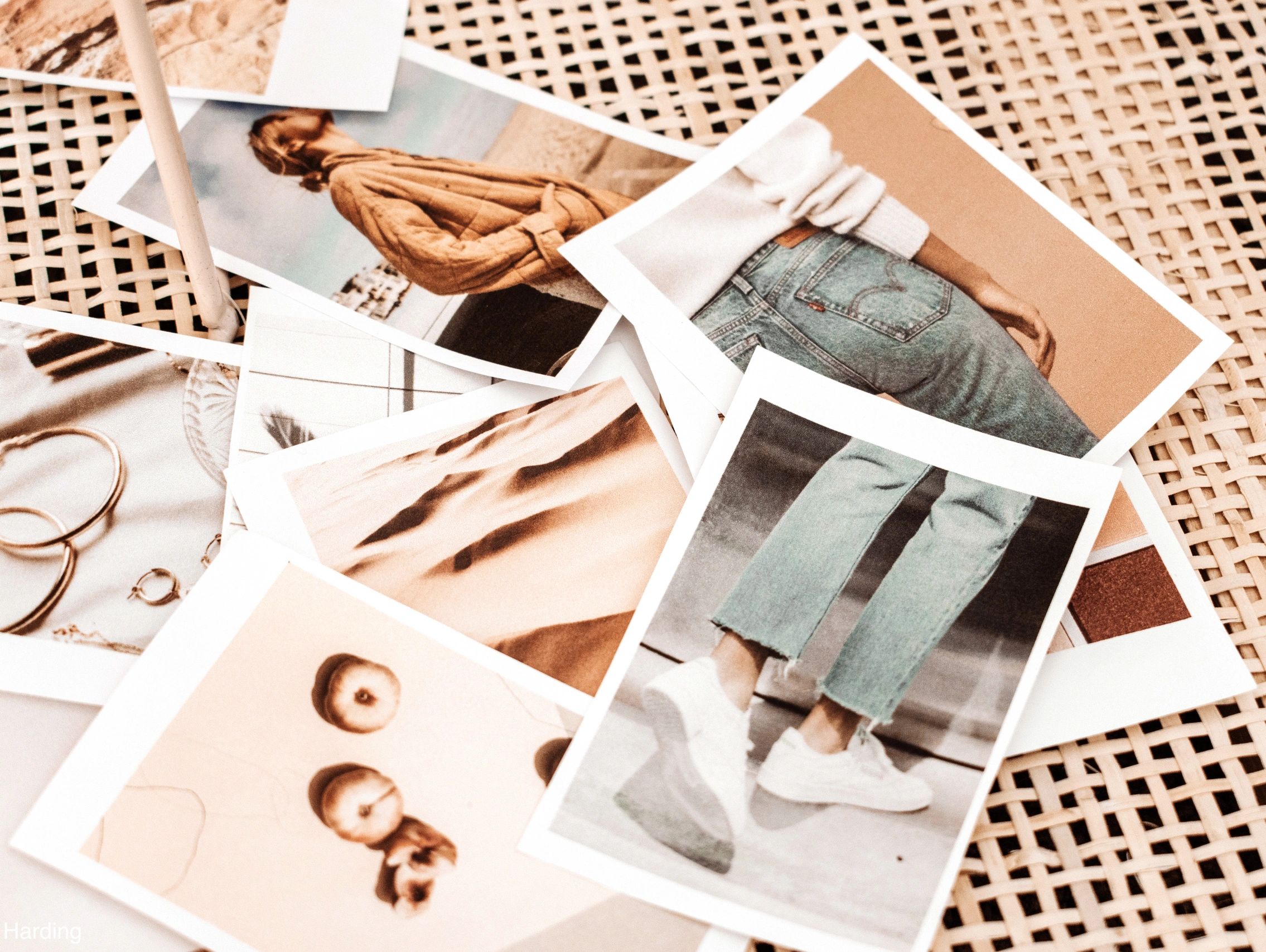 An assortment of photos scattered across a beige table