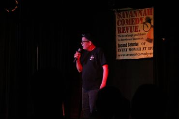 Comedian Brian Patafie performing/speaking as part of his stand up comedy routine.
