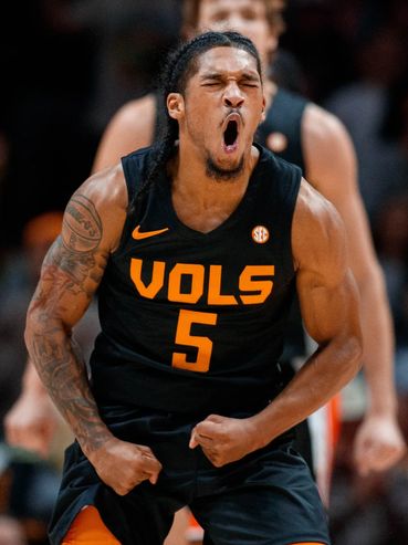 Basketball player in a black VOLS jersey passionately celebrating during a game.
