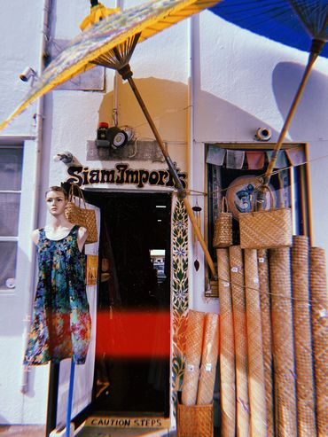 Shop entrance with mannequin and bamboo items.