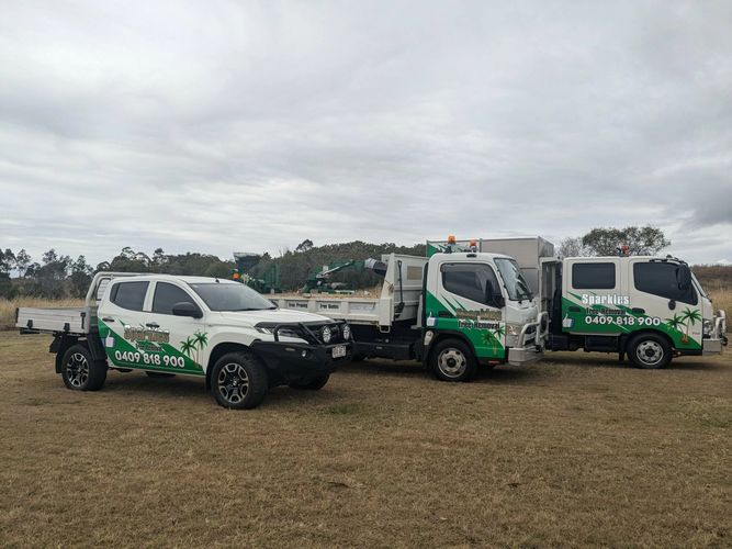Stack of books next to pencils in a holder and a camera.