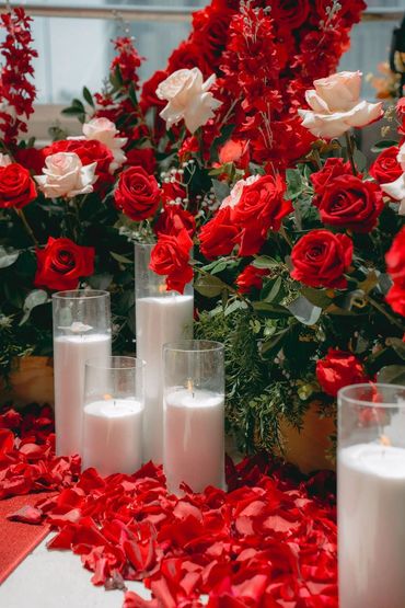 arrangement of red and white roses, candlelight, petals perfectly captures heart of winter romance. 