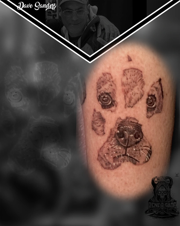 Realistic dog portrait incorporated into a paw print memorial tattoo by Dave Sanders at Renegade Tat