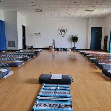 Yoga room interior with Matt practicing on a mat