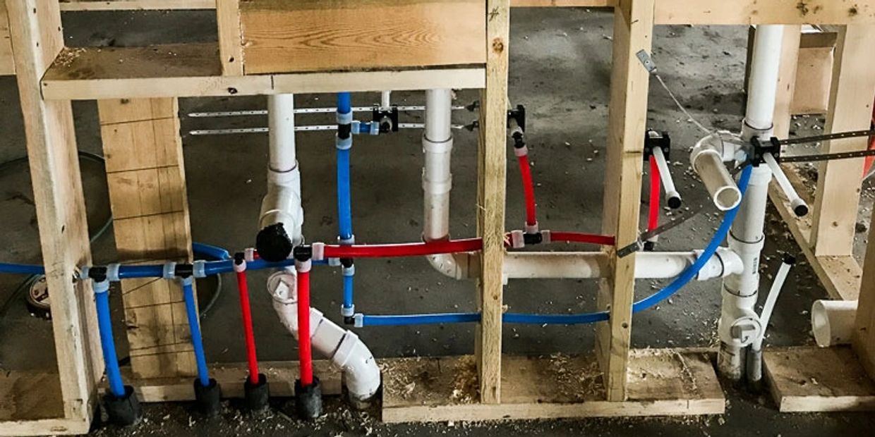 PEX pipe and PVC pipe being installed in the walls 