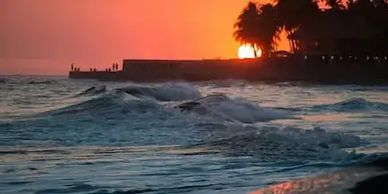 Sunset over the sea at Crete near Marina Port Gouves, with orange skies reflecting on the water.