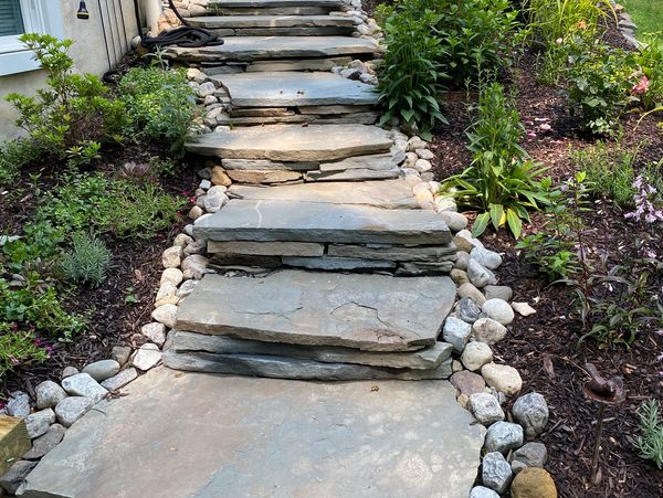 Natural stone walk way with stack stone risers and landscape design 