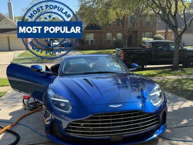 Blue Ashton Martin DB11, being detailed inside with "most popular" on the top left corner