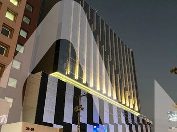 Modern building with vertical lighting at night.