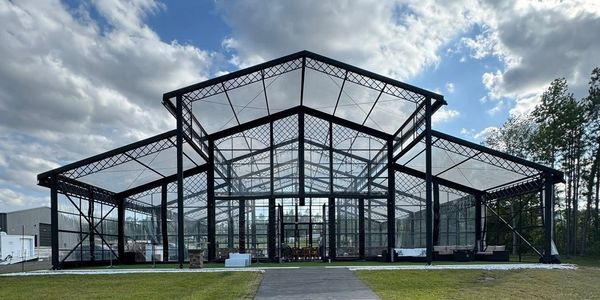 clear structure wedding and event venue in statesboro, ga with blue skies and white fluffy clouds