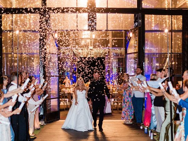Bride and groom at sendoff from a clear structure venue with confetti & guests Statesboro, GA events