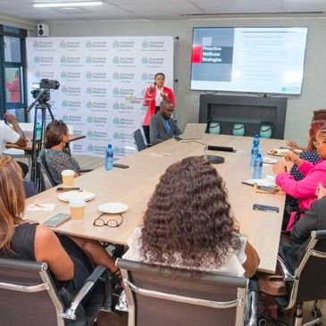 Employees in a wellness workshop. Wellness talk by wellness expert. Hosted by Promote Balance 