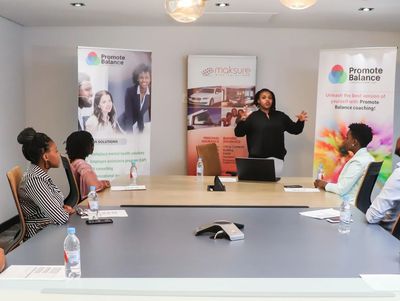 Occupational therapist leading a session on ergonomic practices for a healthier workplace environment