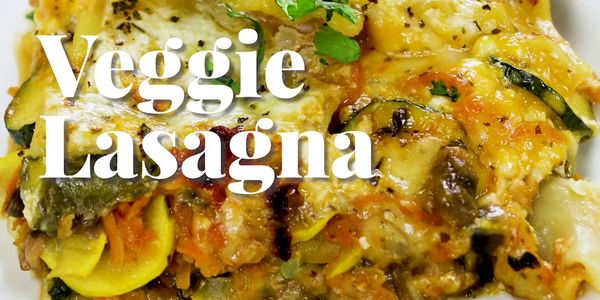 Close-up of cheesy veggie lasagna with zucchini and other vegetables.
