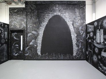 Dark gothic doorway mural on black walls.