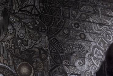 Intricate black and gray abstract patterns in a mural or artwork.