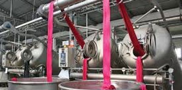 jet dyeing machines being unloaded with dyed fabric being put into tubs