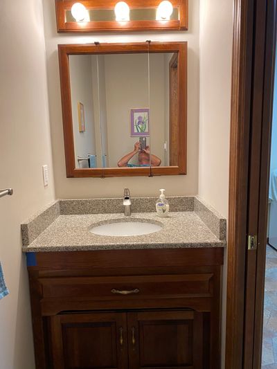 1/2 Bath cherry vanity raised by 6" allowing a new cherry drawer to be added. New quartz countertop 