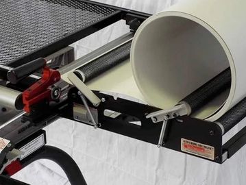 A large white paper roll mounted on a black metal stand with rollers.