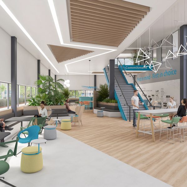 Modern office lounge with wooden accents, plants, and people collaborating.