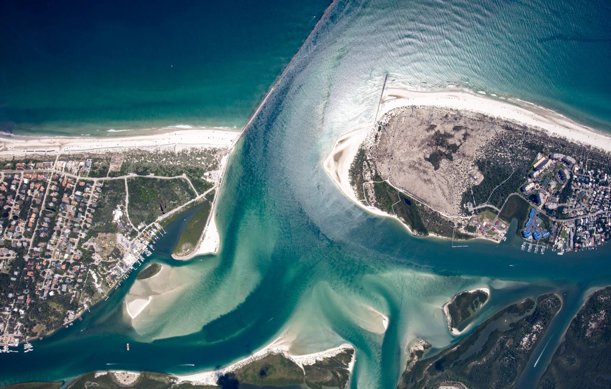 Aerial view of a coastal area with beaches and waterways.