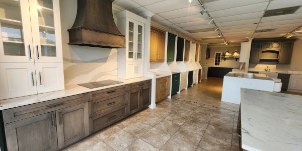 Showroom displaying various kitchen cabinet styles and finishes.