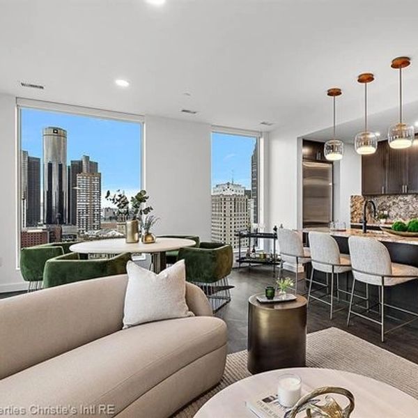 Modern open-concept living space with city views and elegant kitchen.