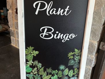 Plant Bingo welcome sign with leafy artwork at a My Plant Wagon event.