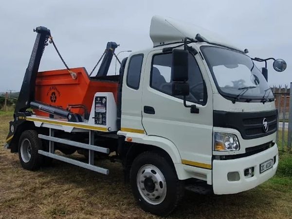 Moss Rommel truck with one of our quality orange skips on its loading bed.