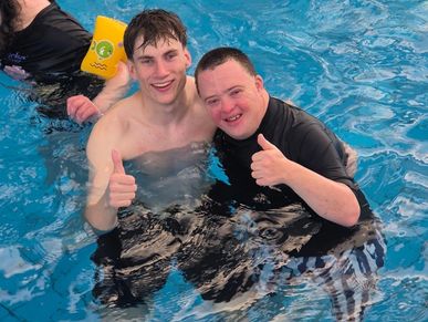 down syndrome NDIS participant with a male Mildura disability support worker in the pool