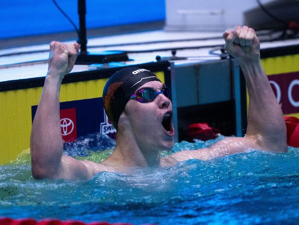 Swimmer celebrates victory in pool.