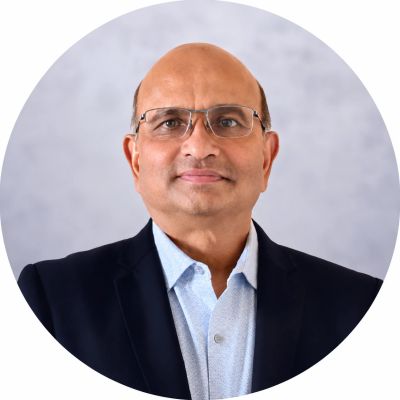 Professional portrait of a middle-aged man with glasses.
