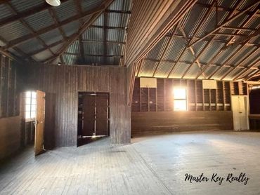 Spacious empty wooden interior with rustic charm and natural light.