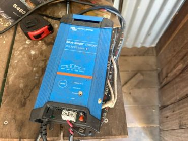 Blue Smart charger placed on a wooden surface.