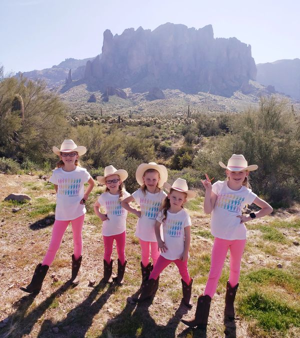 Five girls in front of a mountain
