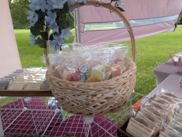 Basket filled with individually wrapped soaps outdoors.