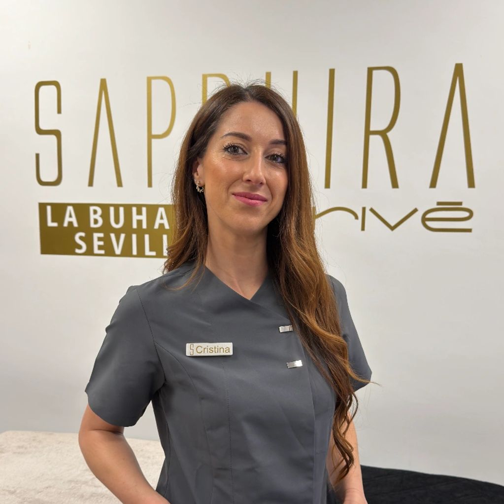 Cristina in a professional uniform stands confidently inside Sapphira La Buhaira Sevilla.