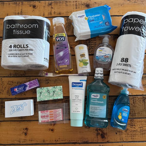 Variety of personal care and hygiene items on a wooden surface.
