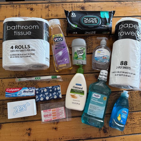 Various personal care and household items on a wooden surface.