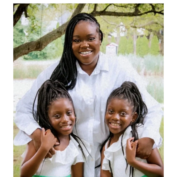 Mother and twin daughters smiling 