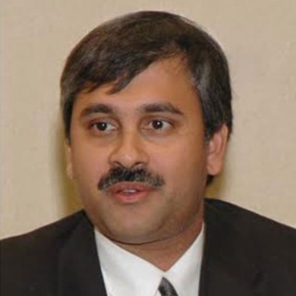 Portrait of a man in formal attire with a mustache.